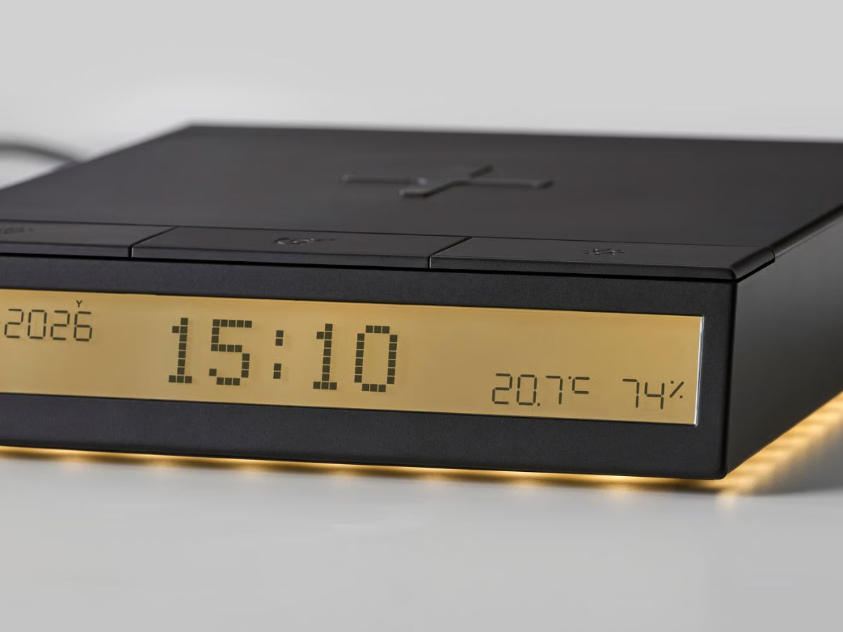 IKEA STENGRÖNSKA alarm clock showing time and room information beside a phone